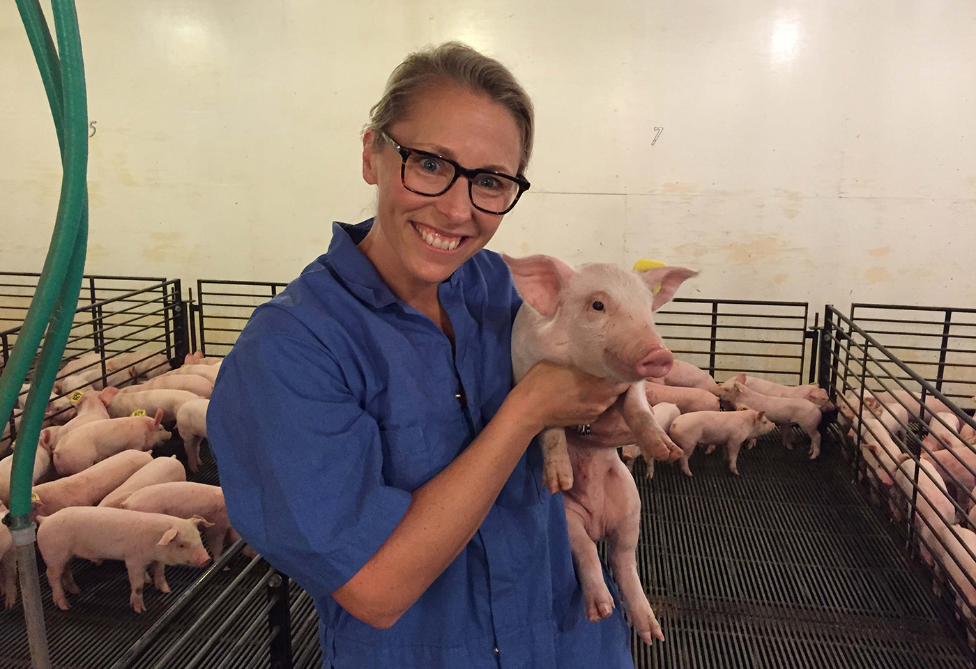 Kristen Peck holding a piglet