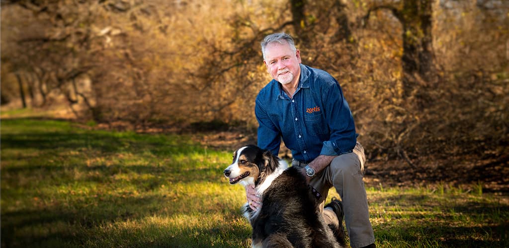 Dr. Mike McFarland with dog in field