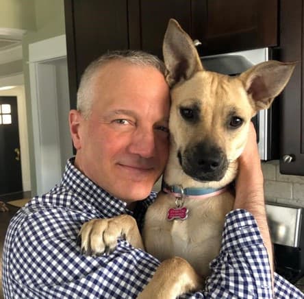 Man in checkered shirt with dog