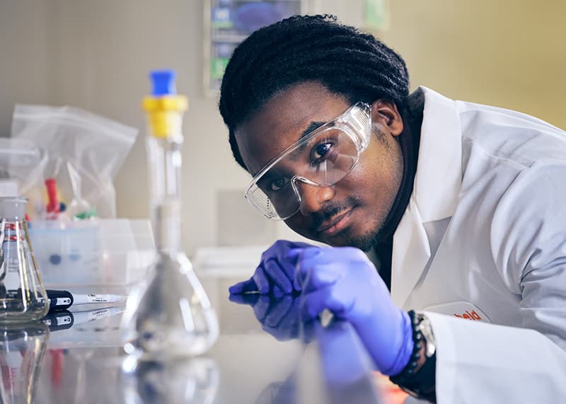 Zoetis employee wearing safety goggles in production