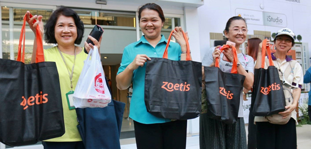 Thai women holding Zoetis branded bags