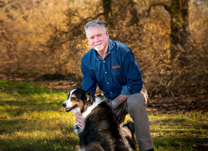 Dr. Mike McFarland with dog in field