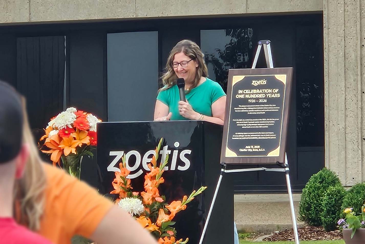 Amanda McCarty, Zoetis Charles City site lead, addresses colleagues and their families during the site's 100th anniversary celebration.