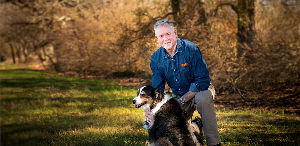 Dr. Mike McFarland with dog in field