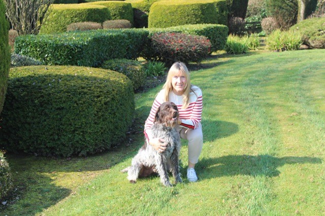 Zoetis veterinarian posing outside with pet dog