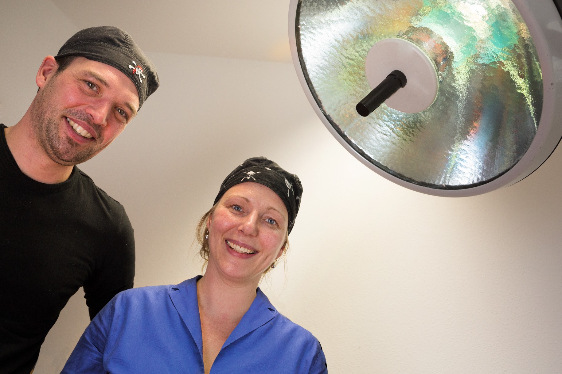 Two veterinary staff members smiling in surgical caps - Zoetis